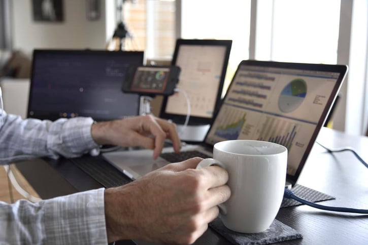 coffee work station multitasking computer data screen, employee multitasking, employee moonlighting or trying to do multiple tasks