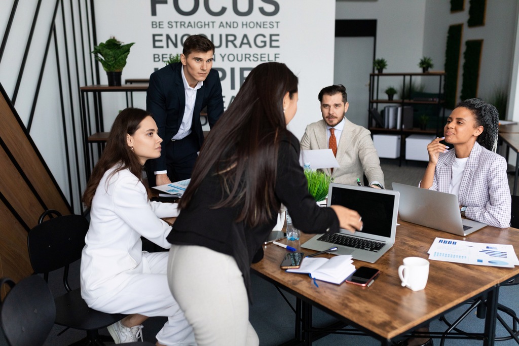 company employees discussing during a meeting in workplace