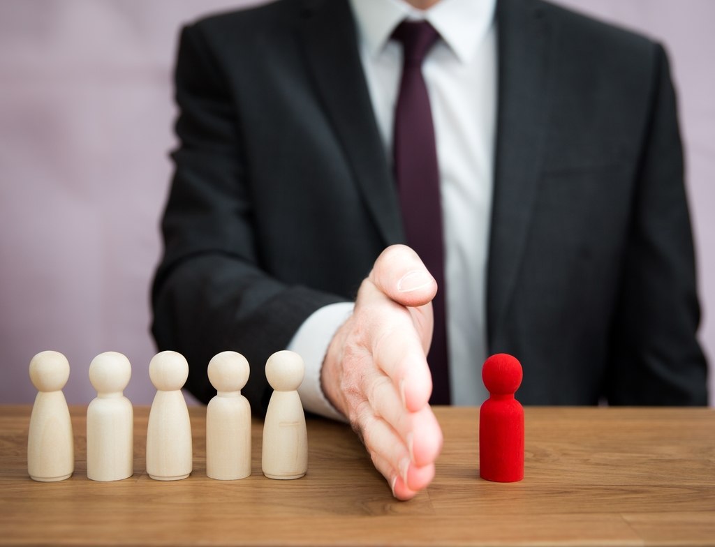 employer separating wooden block symbolising employees from the team