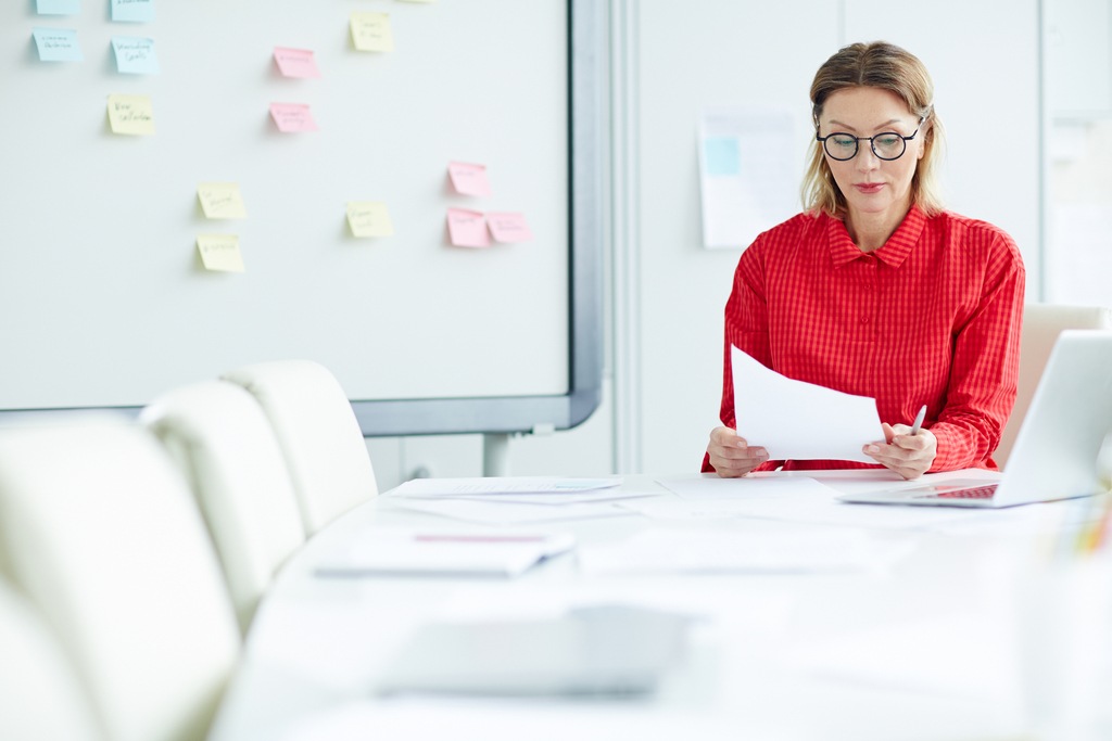 female employee working alone in meeting room