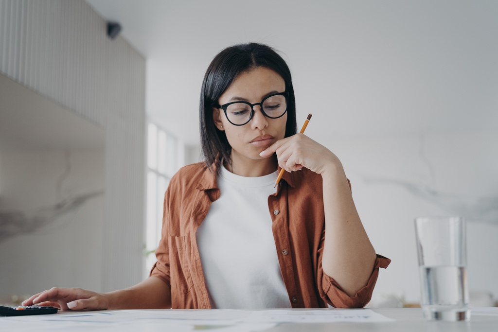 female with glasses calculating overtime