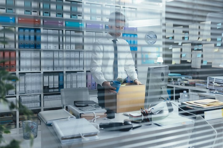 employee packing up his office due to compulsory redundancy