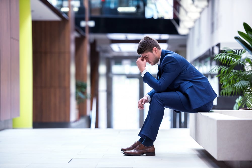 frustrated young business man working on laptop computer at office