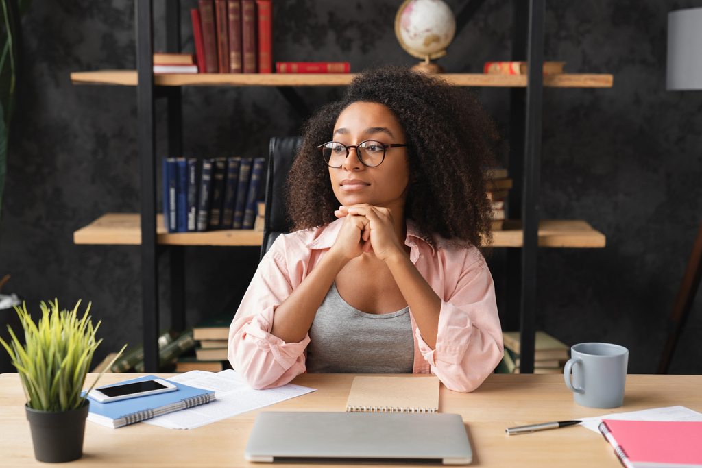 girl relaxing at desk on workplace after working remotely