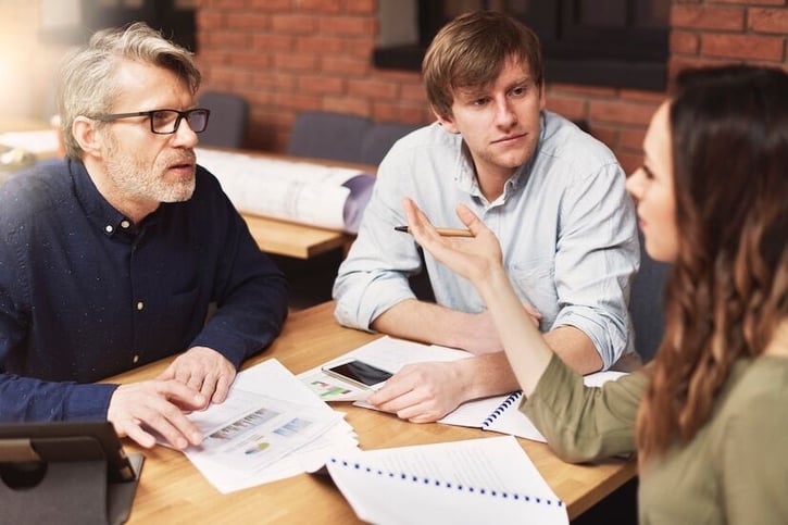 Team members discussing how many PTO days is normal during a workplace meeting
