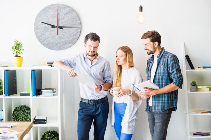 Mitarbeiter diskutieren die Arbeitszeitmodelle im Büro.