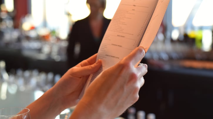 hands holding bar menu