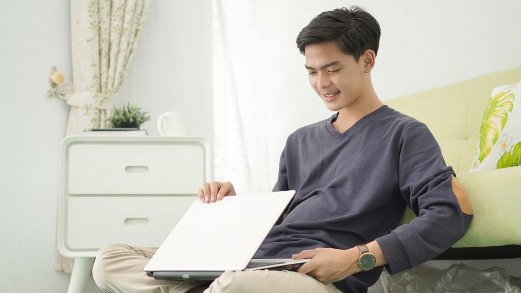 handsome-asian-man-turning-off-his-laptop-after-wo-2021-09-04-15-57-44-utc_50