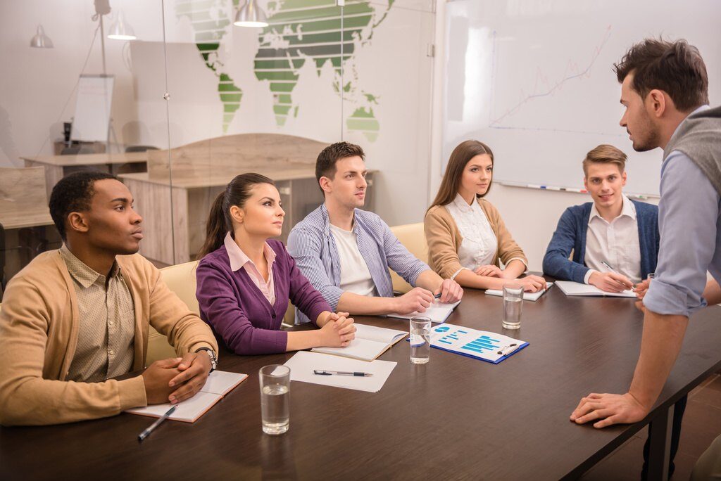 hiring manager or recruiter asking questions to candidates during group interview
