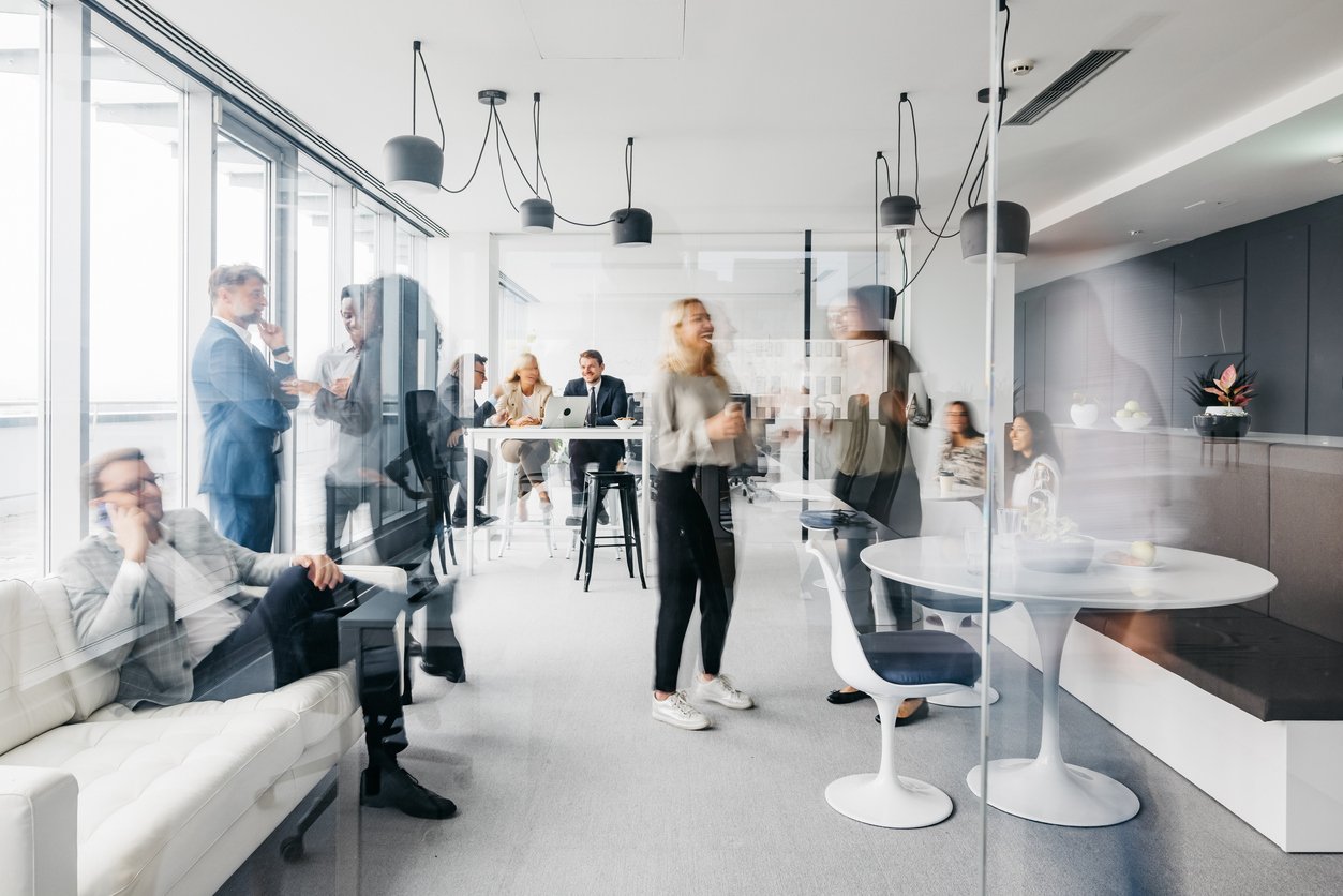 lively office break room, employees talking to each other while on break