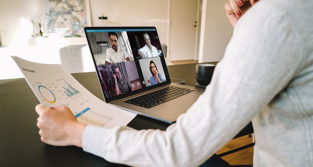 manager in meeting with remote team discussing data