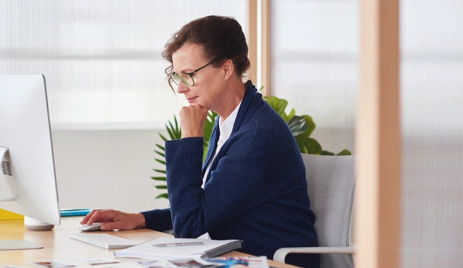 mature woman using laptop to plan work schedules