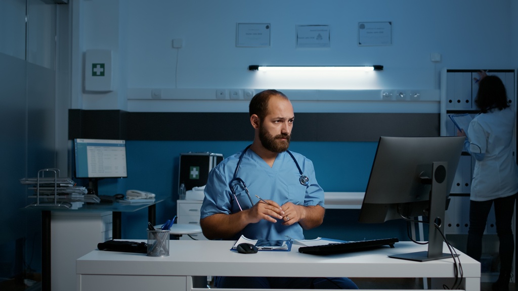medical-assistant-standing-at-desk-in-hospital-off-2022-11-09-03-06-47-utc_50