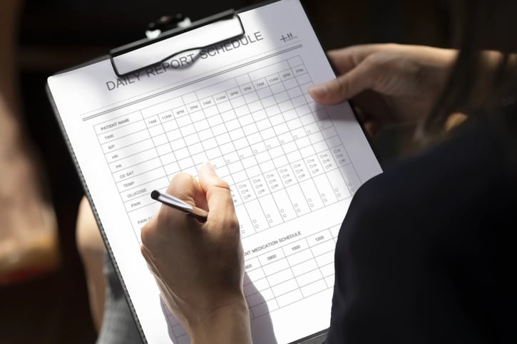 daily schedule or time card being filled by employee