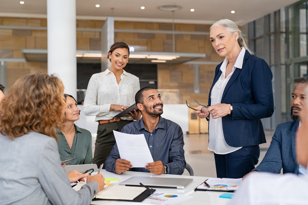 coworkers in meeting room discussing a project