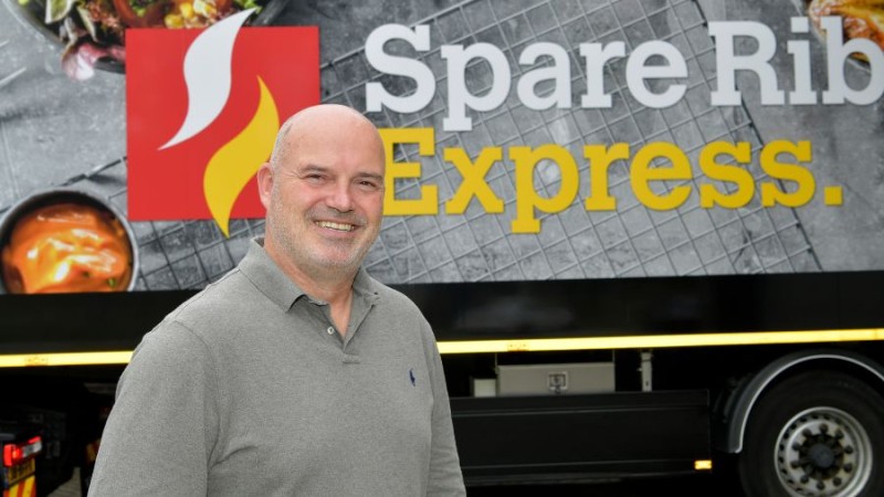 Company mand smiling in front of spare rib express