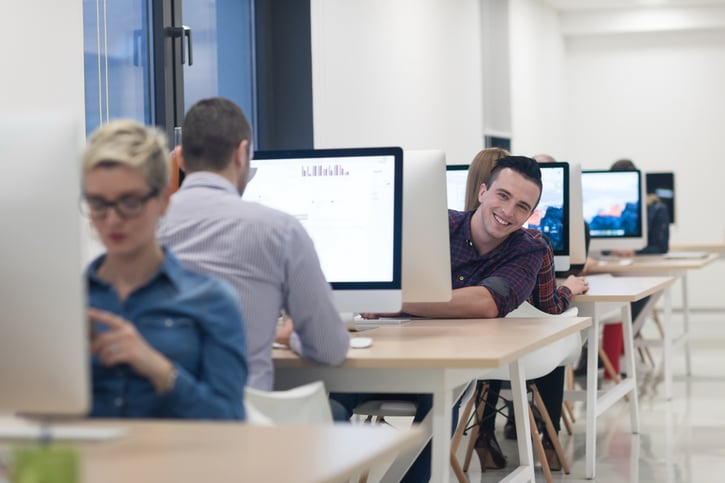 employees working in office at their desk symbolising different working styles
