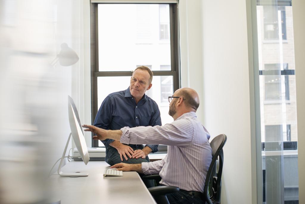 two-business-colleagues-in-an-office-talking-and-r-2022-03-04-02-25-37-utc_50