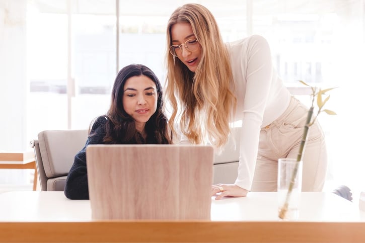 two-women-working-together-with-laptop-at-the-offi-2023-01-31-03-05-29-utc_50