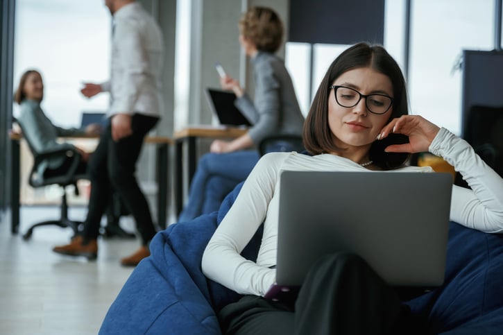 unbothered employee sitting in bean bag chair at work symbolising insubordination at work