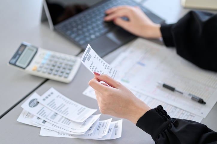woman entering expenses in accounting software