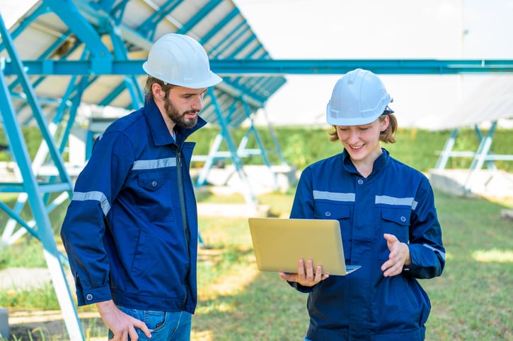 field service managers looking at project on laptop