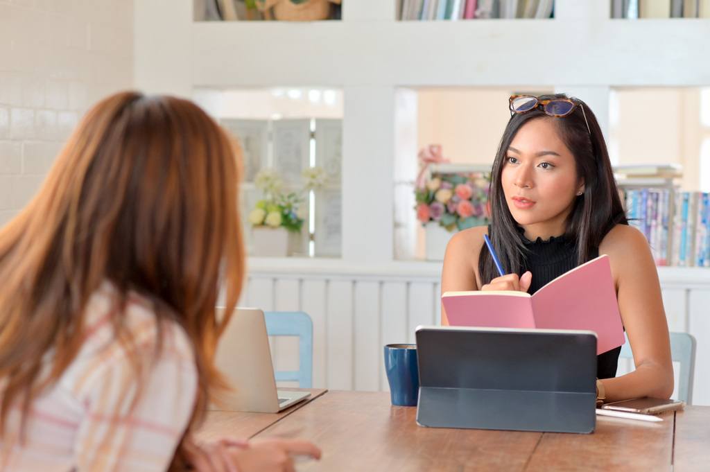 young female executive meeting with employee