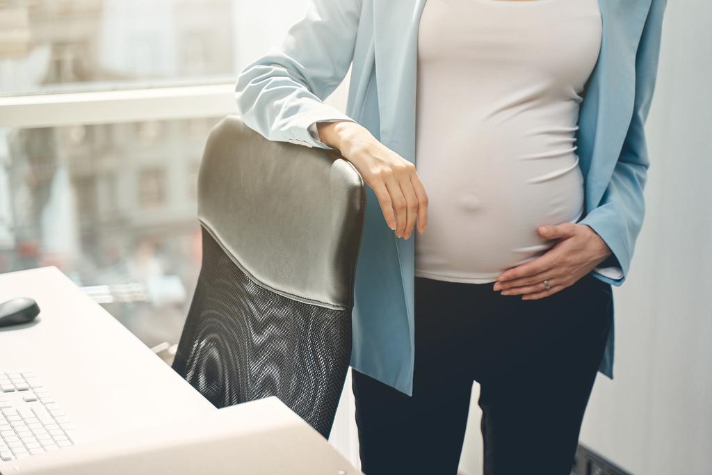 young-pregnant-lady-standing-by-office-chair-2022-02-07-23-12-41-utc_50