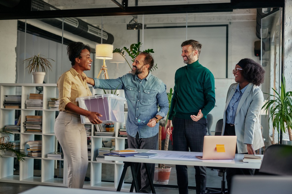 Coworkers greeting colleague returning to work
