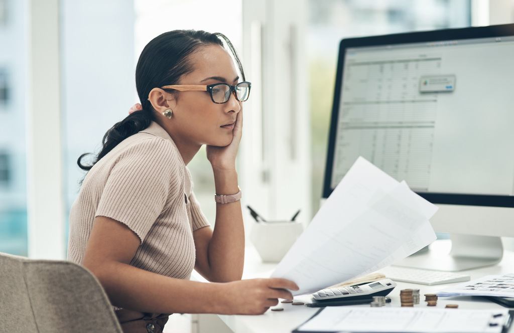 stressed businesswoman looking at documents
